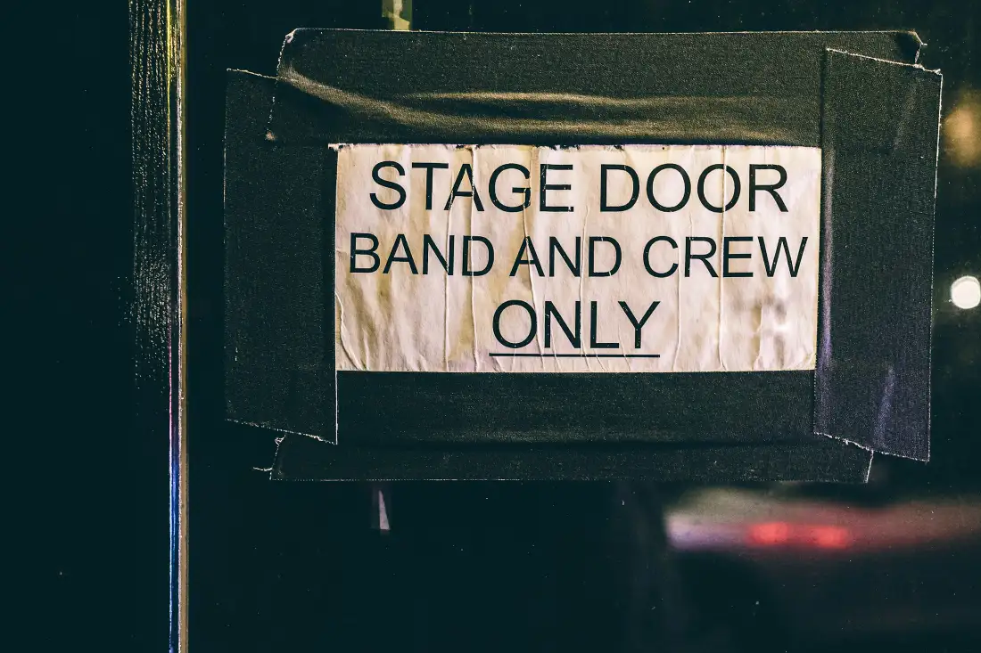 Stage door sign reading Band and Crew Only