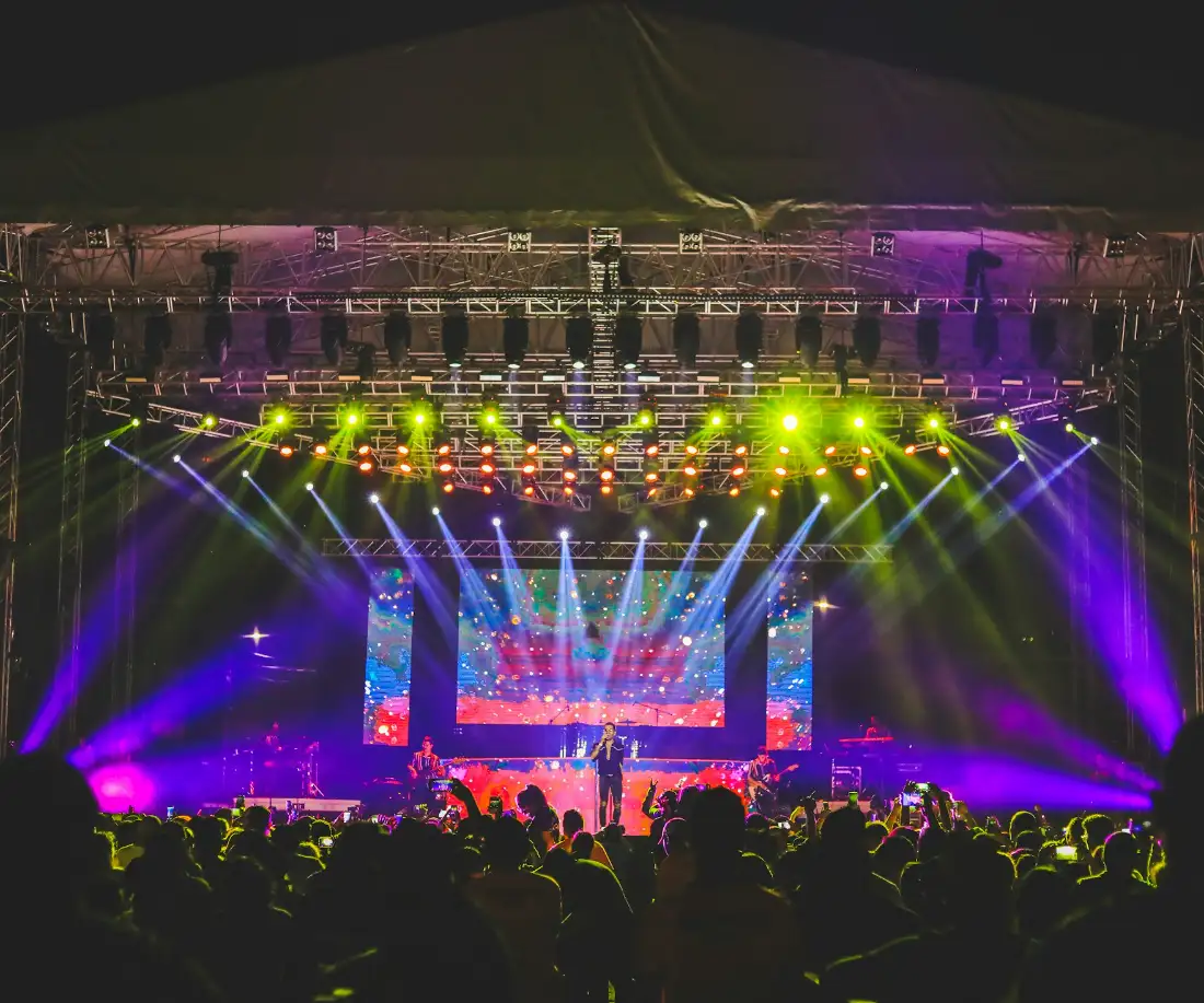 Concert stage lit by a full truss lighting rig