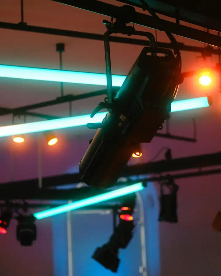 Lighting fixture rigged on truss above a stage